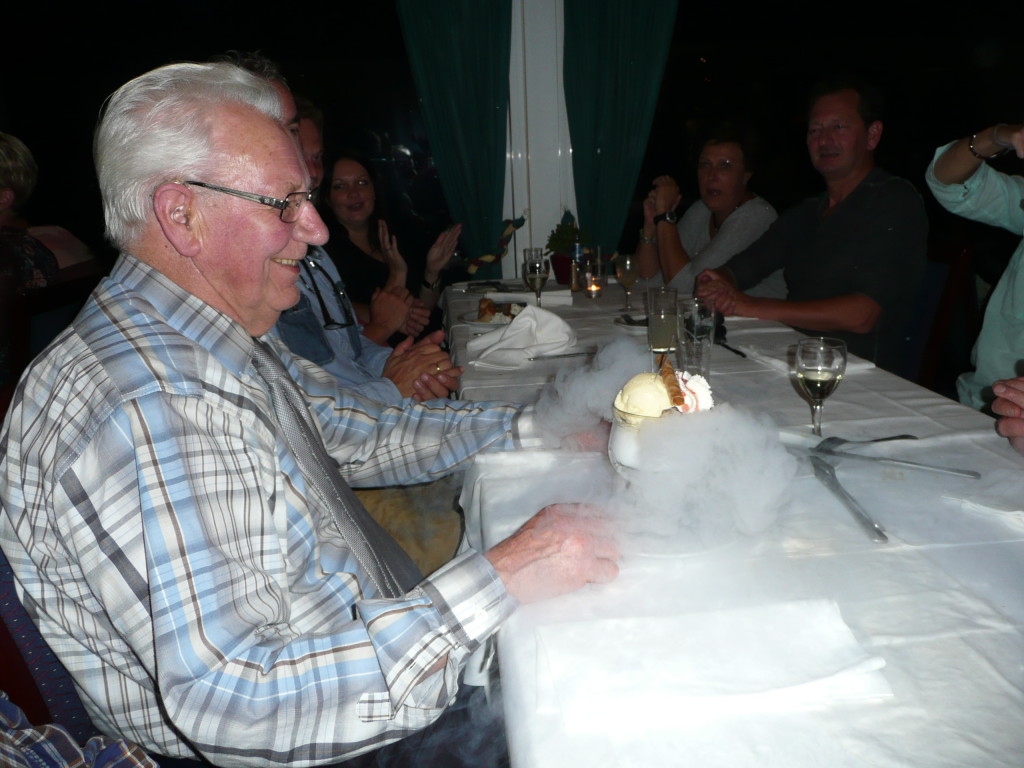 My grandfather receives a complimentary dessert and a present from the restaurant